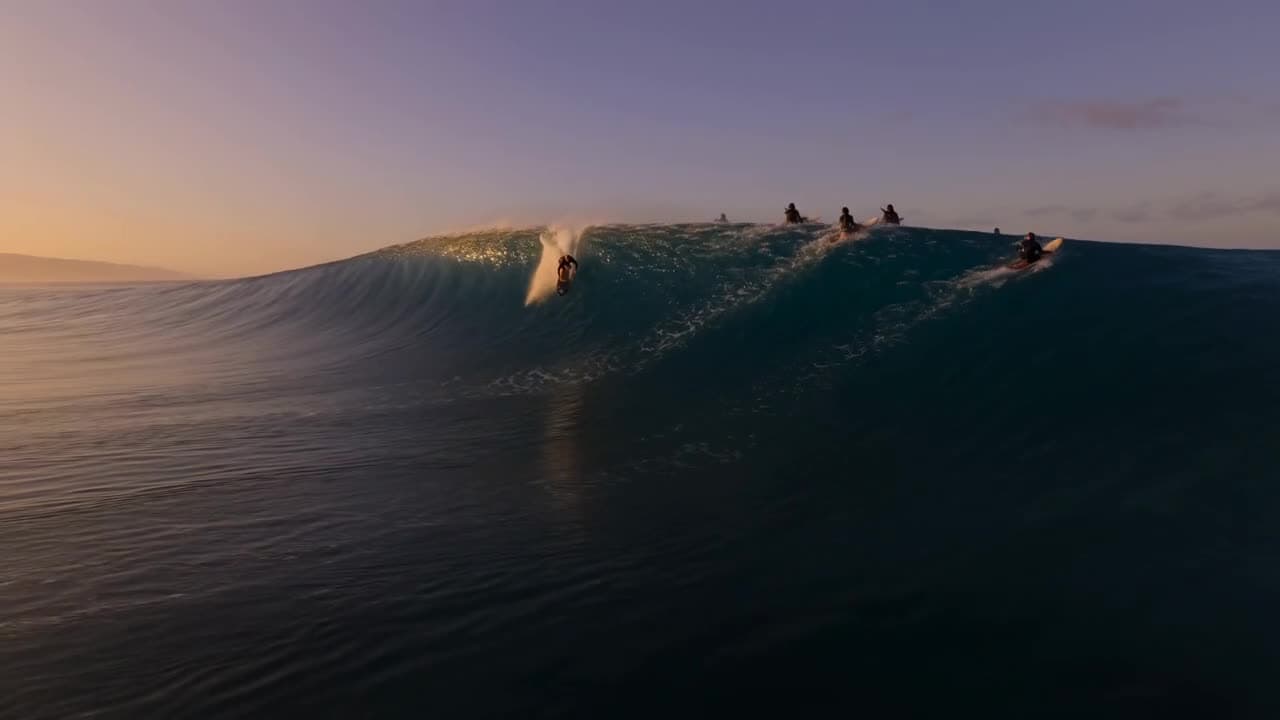 Surfers riding a glassy wave at golden hour — a Seedance 2.0 generation