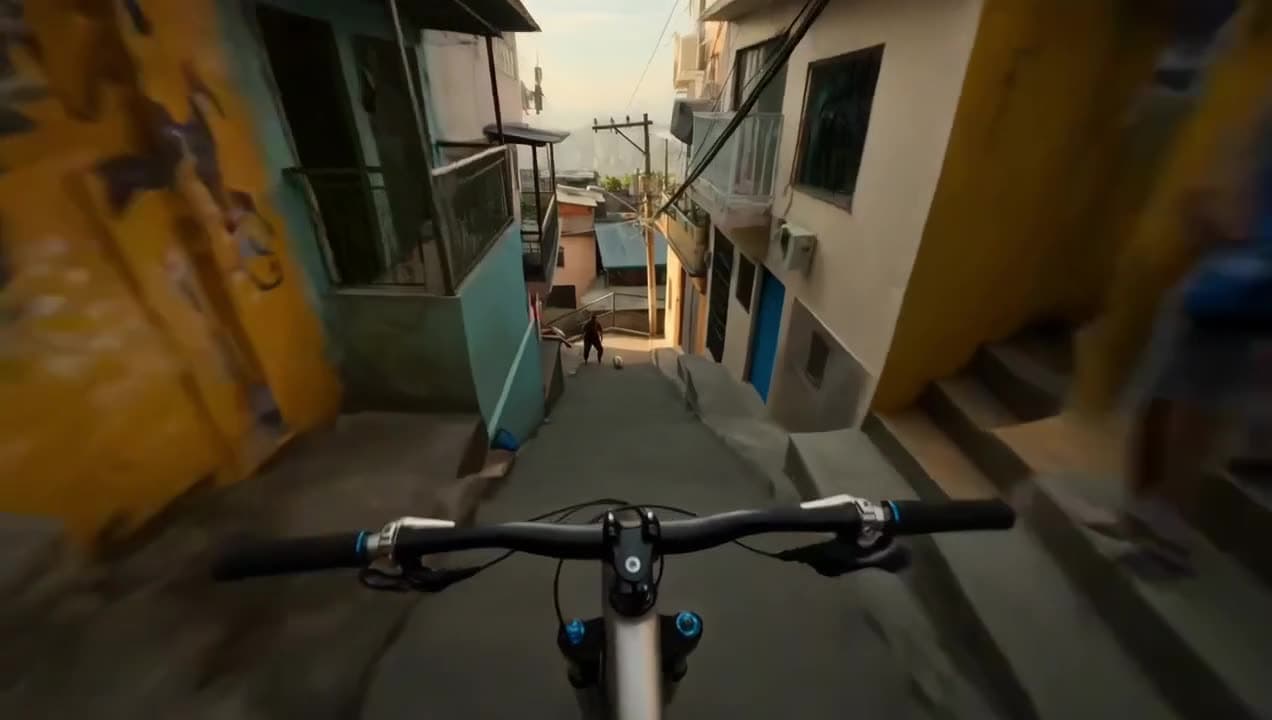A fast first-person POV riding a bike down a staircase over a golden-hour cityscape — a Seedance 2.0 generation